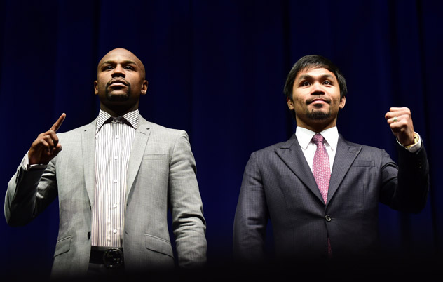 Boxers Manny Pacquiao (R) from the Philippines and Floyd Mayweather from the US gesture while posing during a press conference on March 11, 2015 in Los Angeles, California, to launch the countdown to their May 2, 2015 super-fight in Las Vegas. AFP PHOTO/ FREDERIC J. BROWN        (Photo credit should read FREDERIC J. BROWN/AFP/Getty Images)