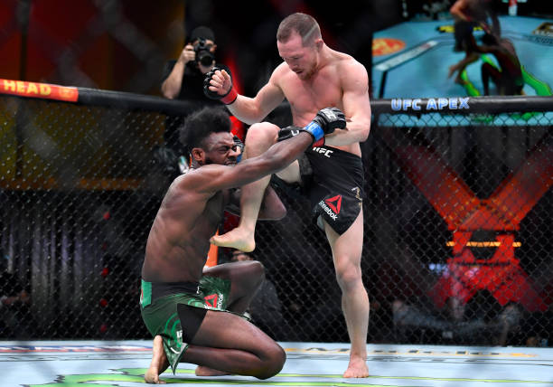 LAS VEGAS, NEVADA - MARCH 06: (R-L) Petr Yan of Russia delivers an illegal knee against Aljamain Sterling in their UFC bantamweight championship fight during the UFC 259 event at UFC APEX on March 06, 2021 in Las Vegas, Nevada. (Photo by Chris Unger/Zuffa LLC)